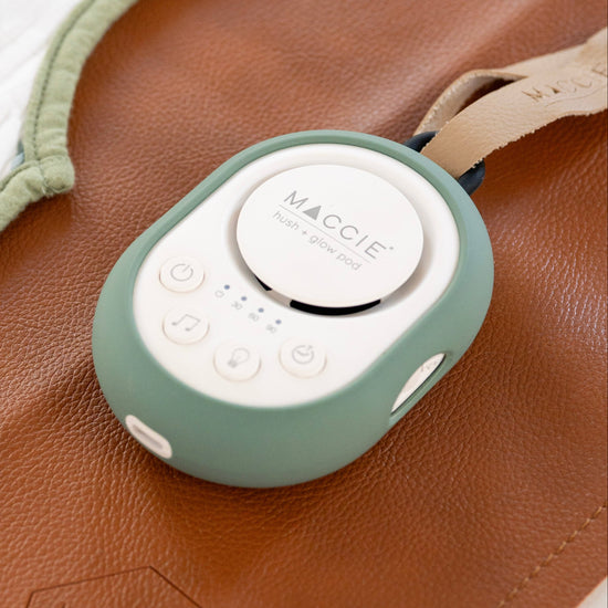 Baby bib with leaf pattern and green heating pad on brown surface
