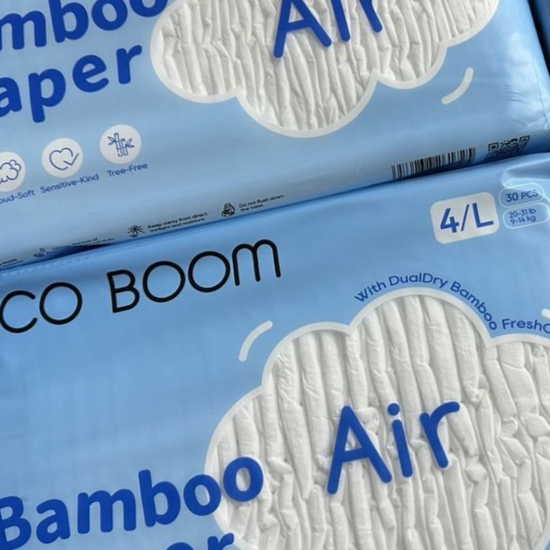 Two packages of CO BOOM Bamboo Diaper Air, size 4/L, stacked on top of each other. The packaging is light blue with white cloud-shaped graphics showing the textured diaper material and blue text.