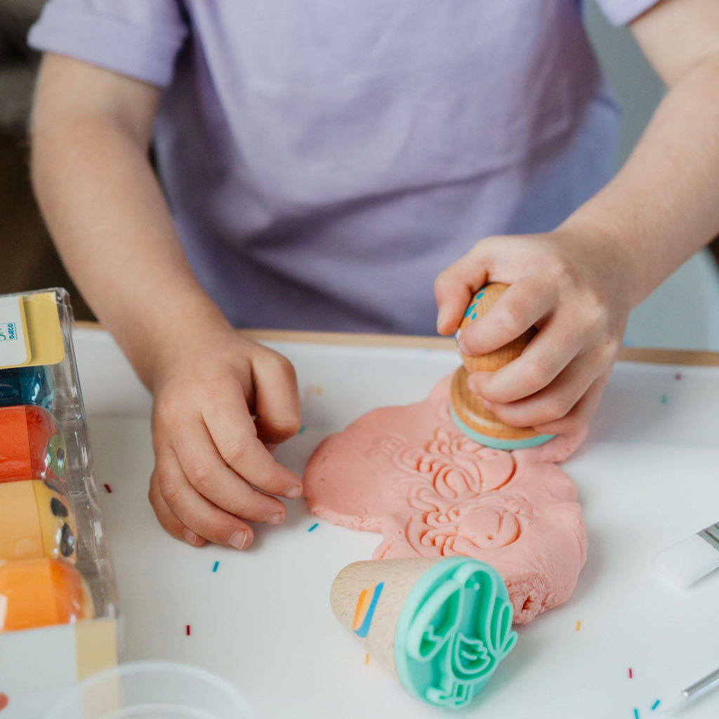 Child playing with colorful toys on a table