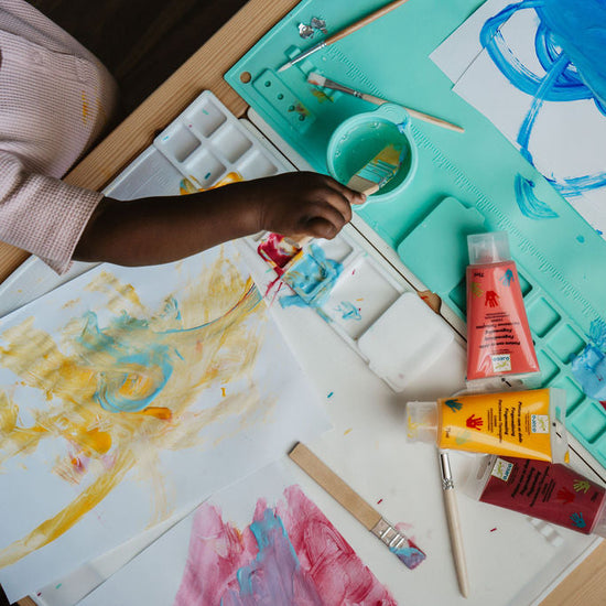 Artistic activity with paint and brushes on a table