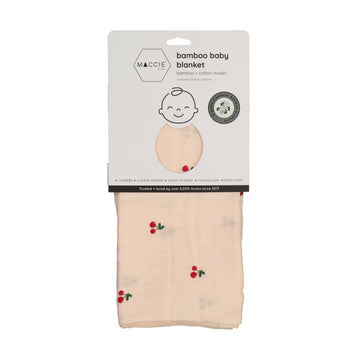 Packaged bamboo baby blanket with cherry pattern on a white background