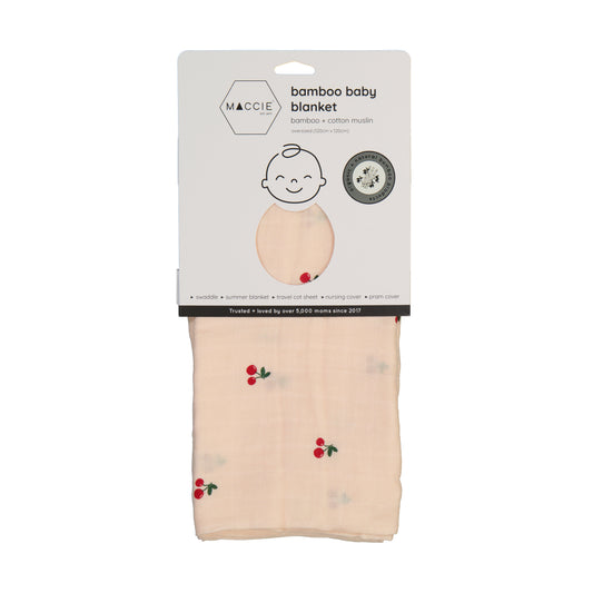 Packaged bamboo baby blanket with cherry pattern on a white background