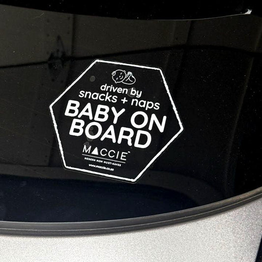 Baby on board sticker on a car seat with 'Maccie' branding