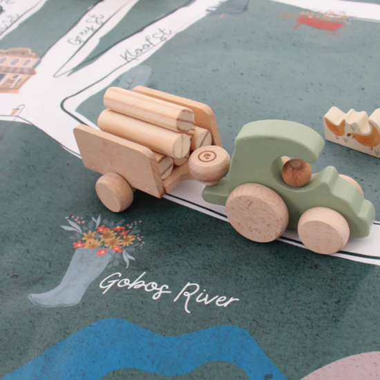 Wooden toy truck with logs on a map of a river